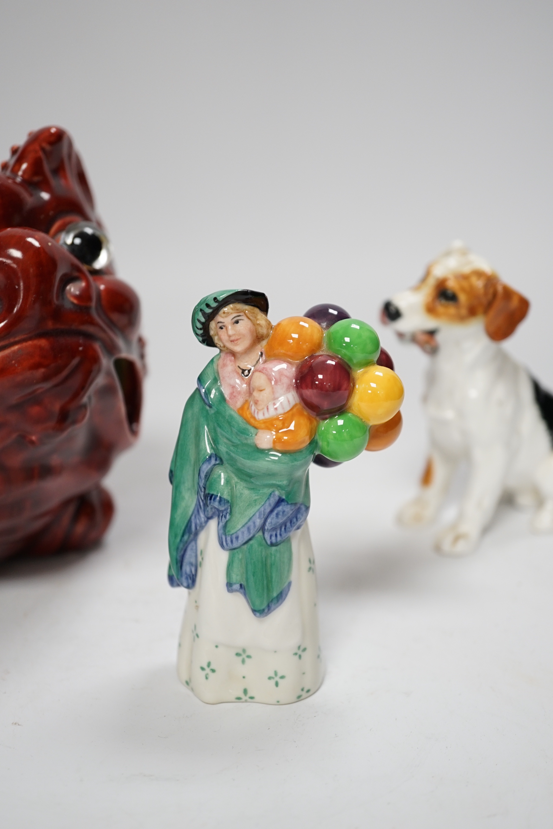 A Burmantofts style grotesque toad spoon warmer, a Royal Doulton dog ornament and The Balloon Seller, toad 18cm long